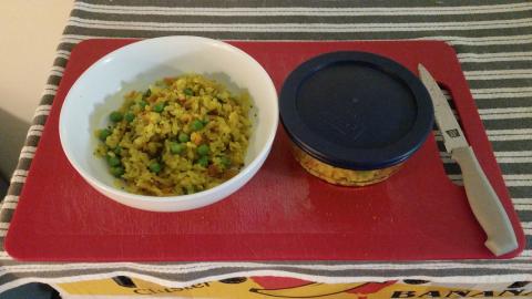 Bowl of seasoned rice flakes beside a similar-sized serving in a Pyrex storage jar.