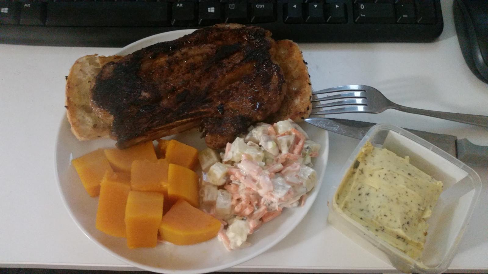 A lamb chop served on buttered Turkish bread served with pumpkin and potato salad.